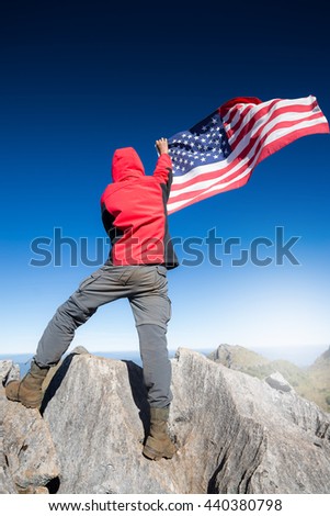 Young man proudly waving the American flag at sunrise, American Celebration
