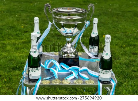 Trophy, medals and a bottle of champagne ready for the winners.