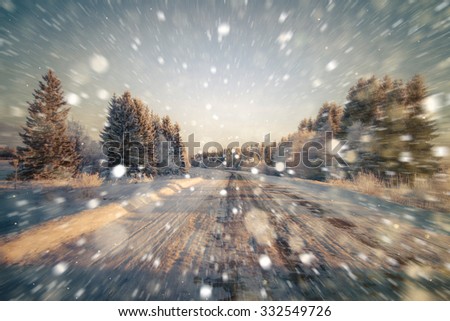 Winter road, sweeping the road, motion blur. Rain, snow, snow turns on the road. Winter background. Copy space.