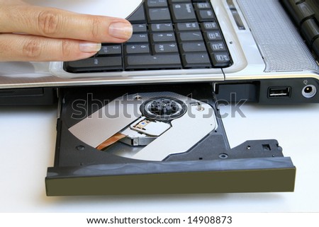 laptop with DVD drive with fingers