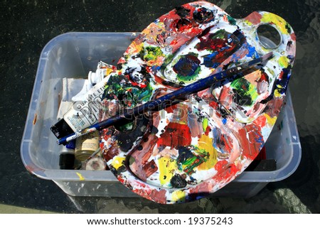 Palette with different kinds of paint with brush
