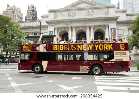 New York City, New York, United States - July 10, 2014:Tourist riding a double-decker tour bus in front of the New York City Library on July 10, 2014