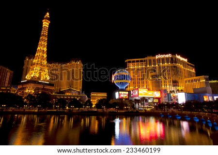 Las Vegas, Nevada, USA - Sept. 25, 2014: Nightlife along the famous Las Vegas Strip with Paris and Planet Hollywood Casinos reflecting in the Bellagio lake in Las Vegas, Nevada, USA - Sept. 25, 2014