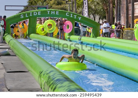West Palm Beach, Florida, USA - Feb 14, 2015: Slide the City where 1000s of people enjoying a 5 block long water slide is set up on Clematis Street in downtown West Palm Beach, Florida on Feb 14, 2015