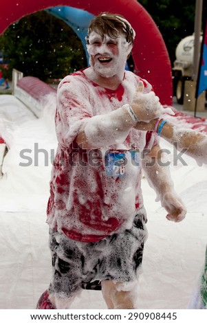 Wilmington, Delaware, USA - June 13, 2015: Man covered in foam at \