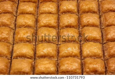 close-up traditional Turkish baklava (sweet dessert made of thin pastry, nuts and honey)