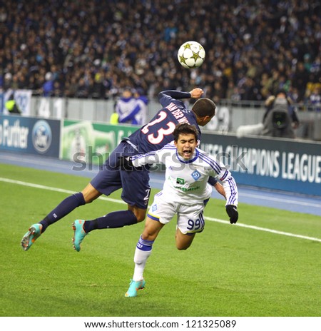 KYIV, UKRAINE - NOVEMBER 21: Gregory van der Wiel of FC PSG (L, #23) fights for a ball with Dudu of FC Dynamo Kyiv (R, #99) during their UEFA Champions League game on November 21,2012 in Kyiv, Ukraine