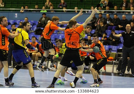 KYIV, UKRAINE - APRIL 2: Ukrainian handball players (in yellow) play a match against Netherlands in qualification for handball EHF EURO 2014 on April 2, 2013 in Kyiv, Ukraine