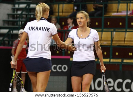 KYIV, UKRAINE - APRIL 21: Lesia Tsurenko (L) and Elina Svitolina of Ukraine cheer up each other during FedCup game against Eugenie Bouchard and Sharon Fichman of Canada on April 21, 2013 in Kyiv