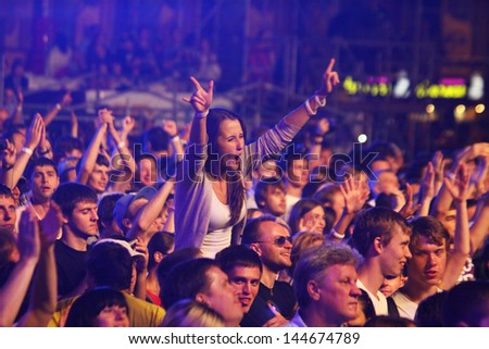 KYIV, UKRAINE - JUNE 30: People dance during Queen performs onstage at charity Anti-AIDS concert at the Independence Square on June 30, 2012 in Kyiv, Ukraine