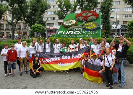 LVIV, UKRAINE - 9 JUNE: German football team supporters pose for a group photo on a street of Lviv city before UEFA EURO 2012 game against Portugal on 9 June, 2012 in Lviv, Ukraine