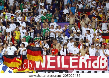 KHARKIV, UKRAINE - JUNE 13, 2012: German fans show their support at Kharkiv Arena during UEFA EURO 2012 game against Netherlands