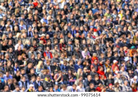 Blurred crowd of spectators on a stadium tribune at a sporting event
