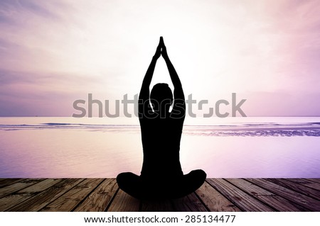 silhouette yoga practicing at sunset, meditation