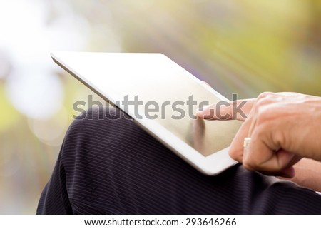 Man using tablet at sunset time