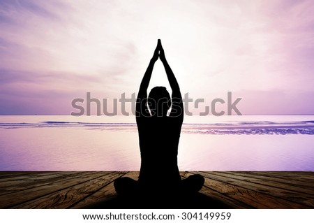 silhouette yoga practicing at sunset, meditation