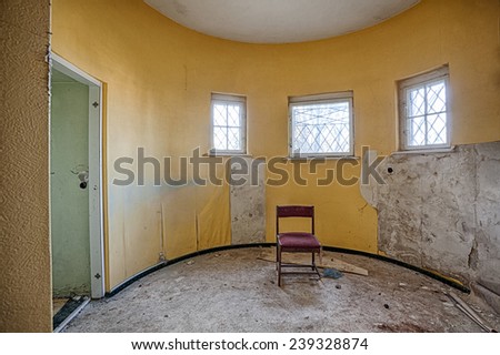 Room in an abandoned house with bars on the windows