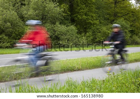 Active family riding bicycle in spring