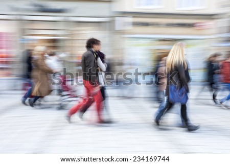 A shopper walking in front of shop window