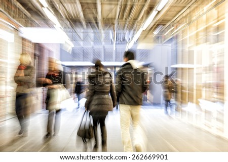 Group of people walking in shopping office,  zoom effect, motion blur