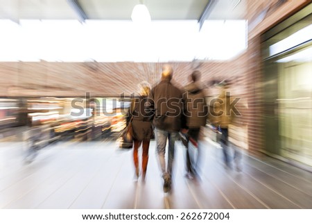 People walking through corridor, zoom effect, motion blur