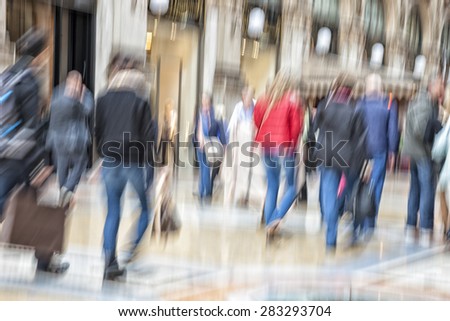 Shopper walking against shop window, zoom effect, motion blur
