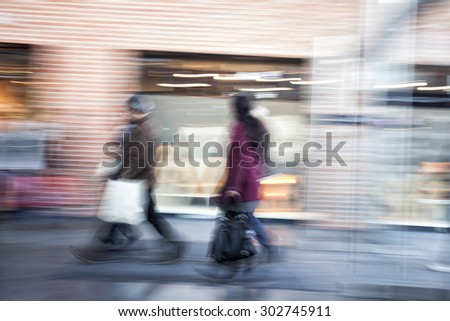 Group of people walking in shopping centre,  zoom effect, motion blur