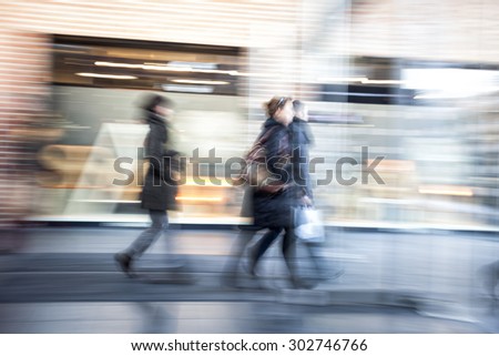 People walking in shopping centre,  zoom effect, motion blur