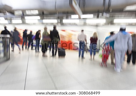 People standing and waiting in subway station, motion blur, zoom effect