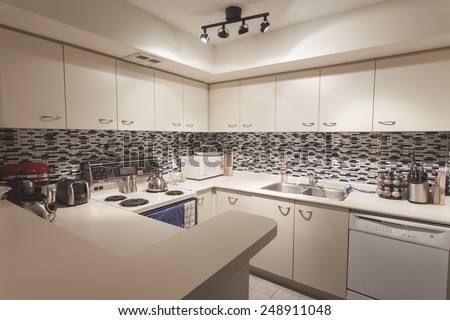 Modern Kitchen Apartment with Black and White Tiled Back Splash