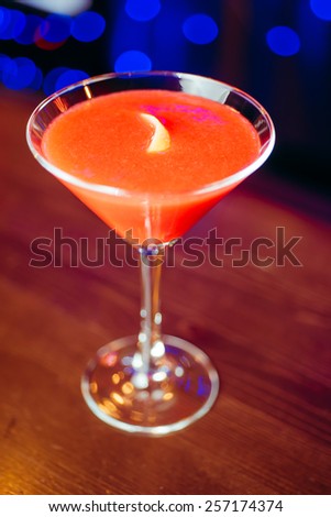 Fresh red frozen cocktail on a color background blur bokeh (bar, club, restaurant)