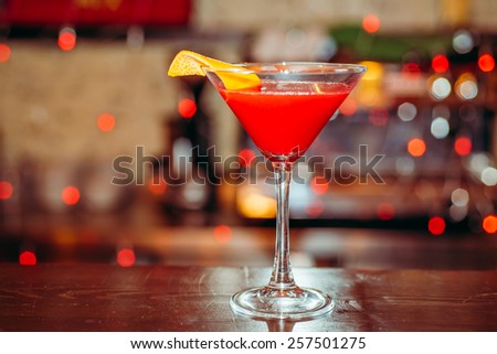 Fresh red frozen cocktail on a color background blur bokeh (bar, club, restaurant)