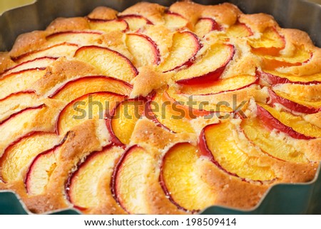 Pastries peach pie in round shape, sliced peaches.