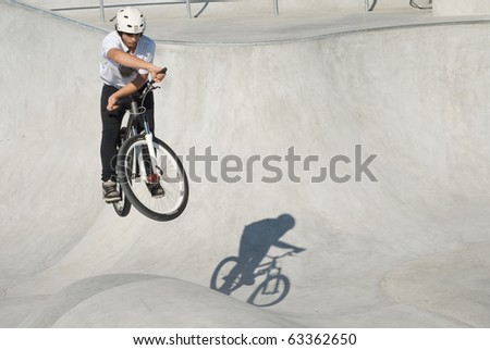 Teenager on Dirt Bike at Skateboard Park