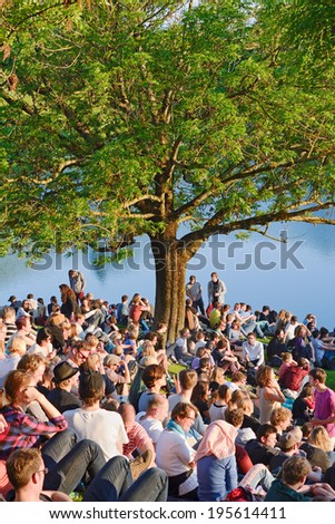 MUNICH, GERMANY - MAY 25, 2014:  After a long winter crowds of fans come out to a early summer music concert at the Olympic Park in Munich.