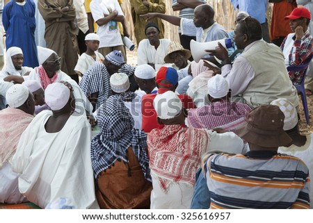 GABU, GUINEA-BISSAU - MAY 9, 2014: village council meeting in rural africa with activists speaking to elders