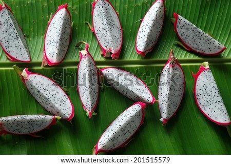 slice fresh dragon fruit on green banana leaf  , dragon fruit