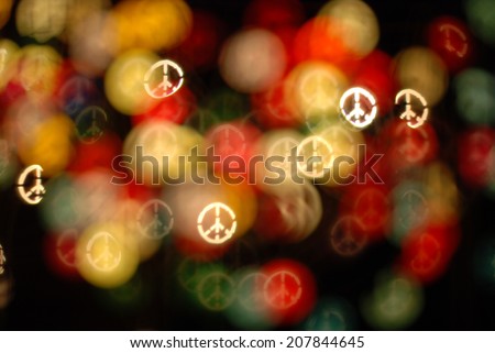 defocused bokeh lights. Filtered peace sign bokeh blurred background. Peace