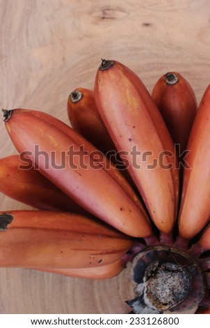 red banana on wooden background.