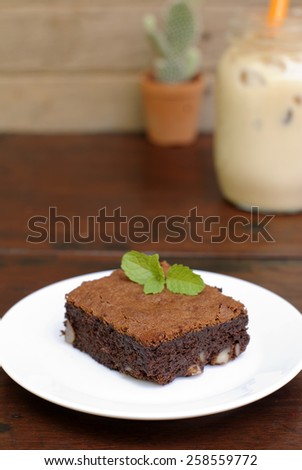 chocolate brownie in plate on wooden table.
