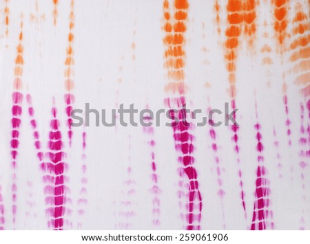 tie dyed pattern on cotton fabric as background.