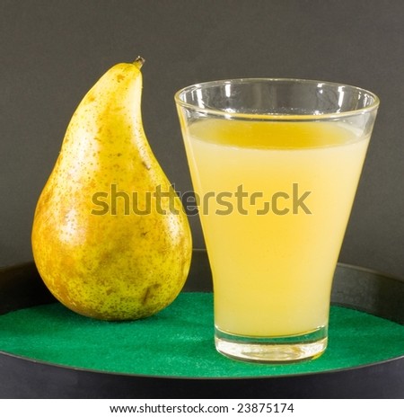 Pear and pear juice on black background