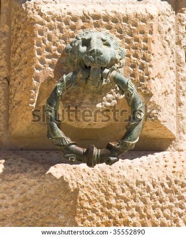 Head of iron lion holding a curtain ring