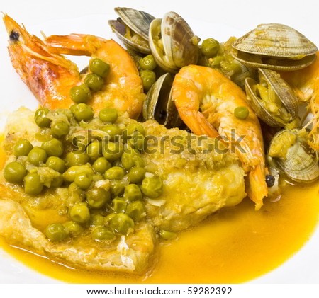Hake prawns cooked with clams and peas with bottom out of focus