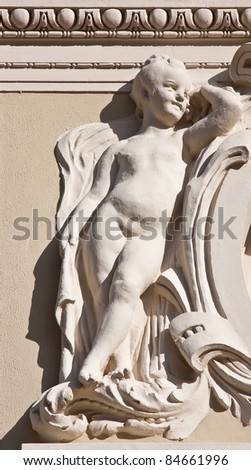 Statue of a boy leaning on his left arm