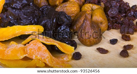 Collected four different kinds of dried fruits: raisins, prunes, figs, and mango