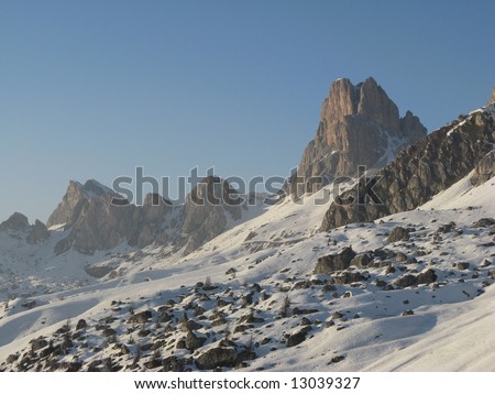 An ancient rock-slide covered with snow at sunset at Passo Giau, Italy