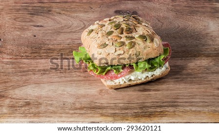 bread with pumpkin seeds stuffed with salami, gorgonzola and salad