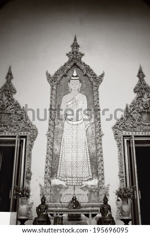 Black and white Sculpture on wall of Standing Buddha / Standing Buddha