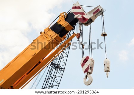Crane at construction site against blue sky /Crane at construction site